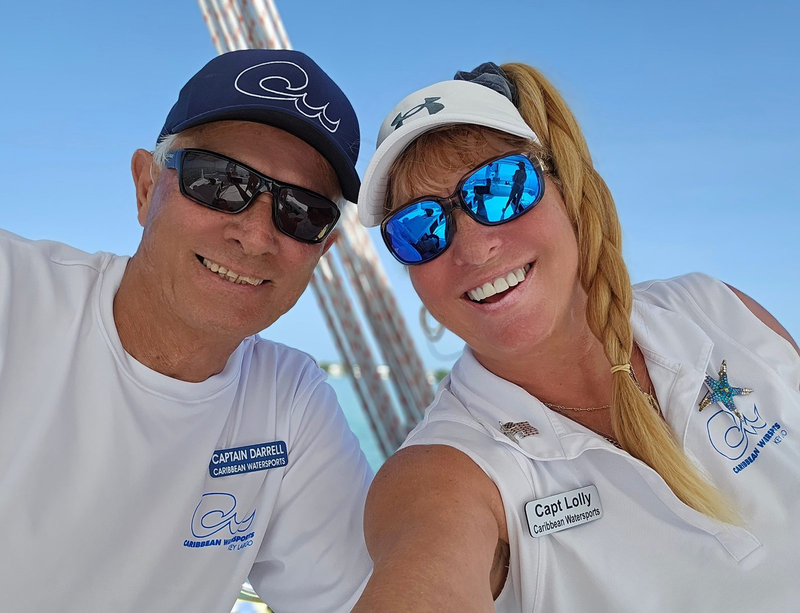 The captain and crew of the Carolina Moon smiling in a selfie under the sail in Key Largo