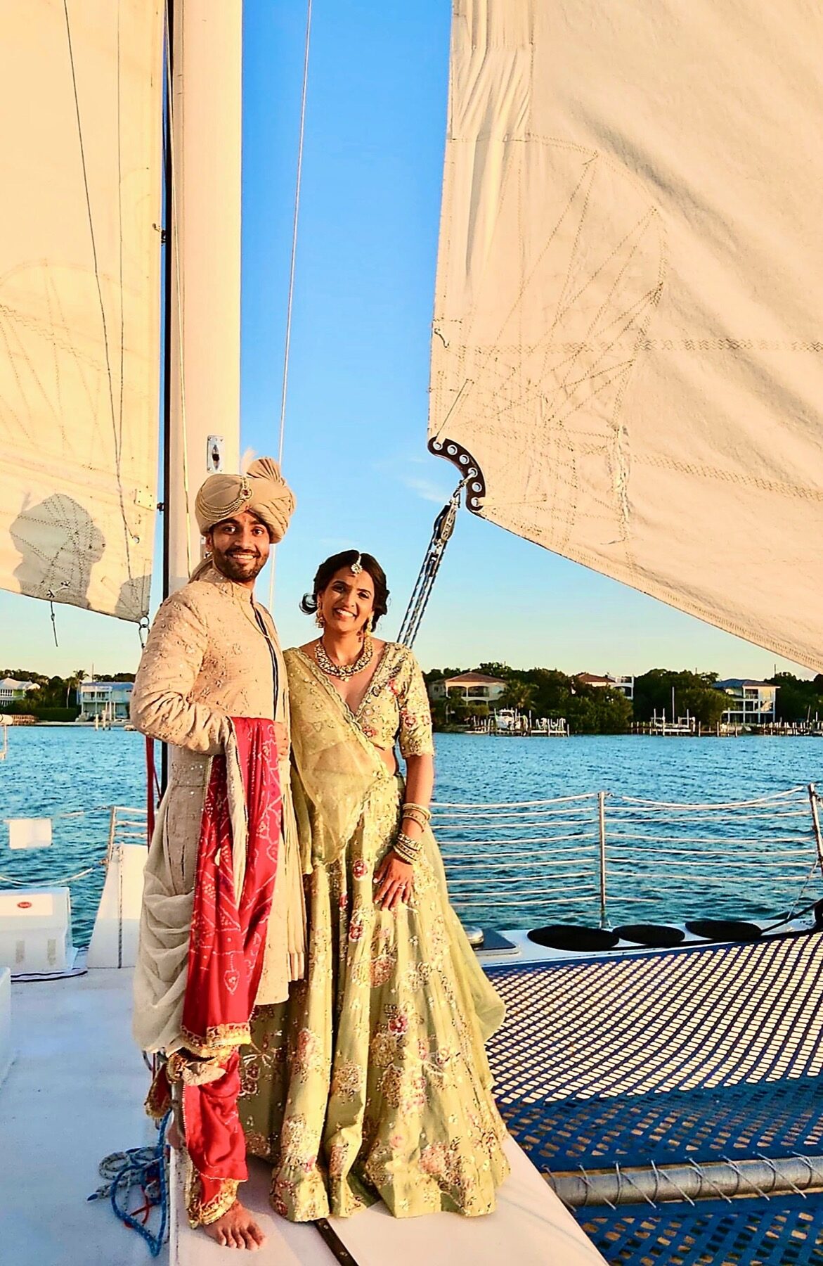 A couple in wedding attire aboard the Carolina Moon catamaran on Florida Bay at golden hour