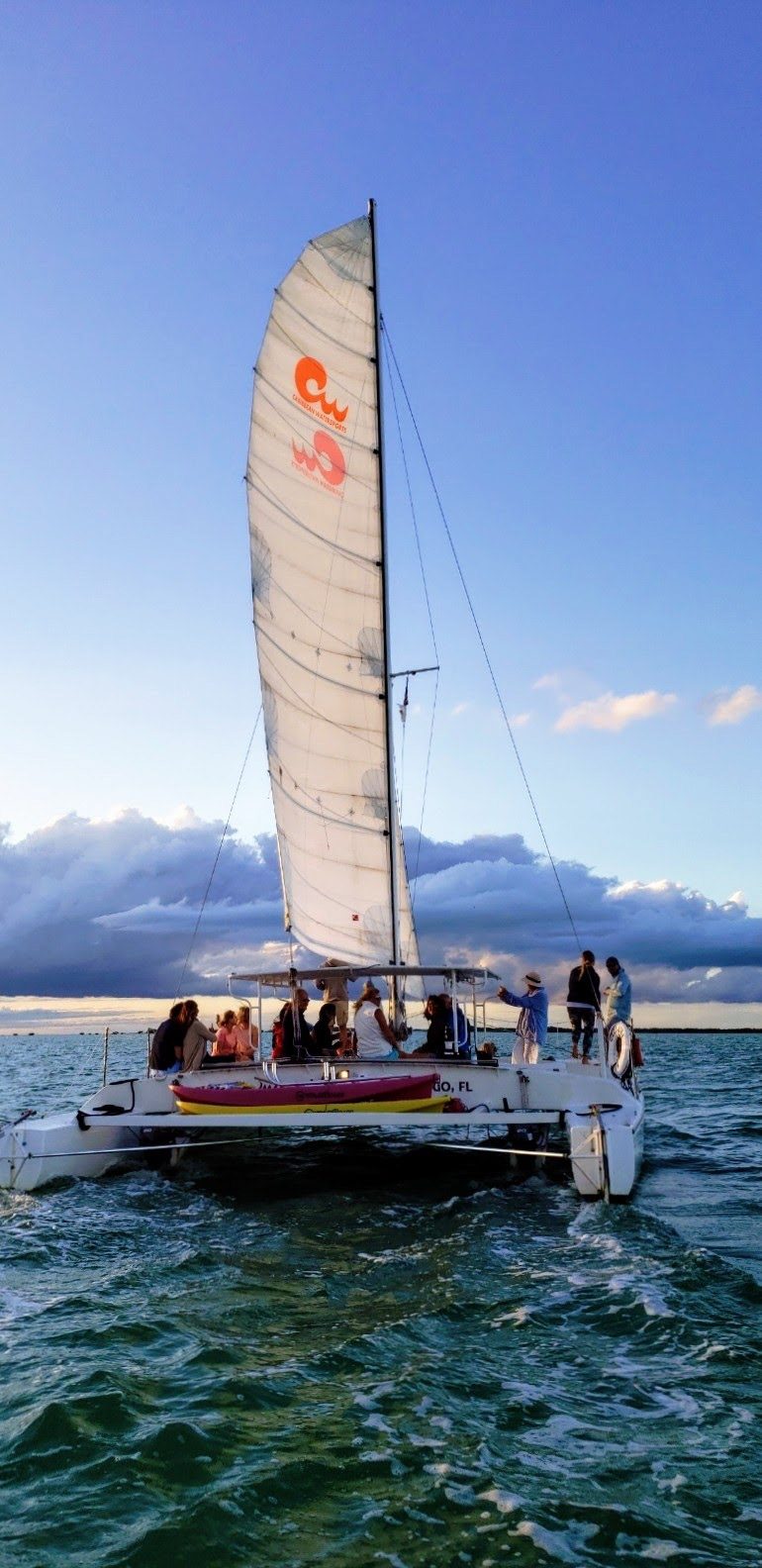 A catamaran on calm water under clear Key Largo boating weather