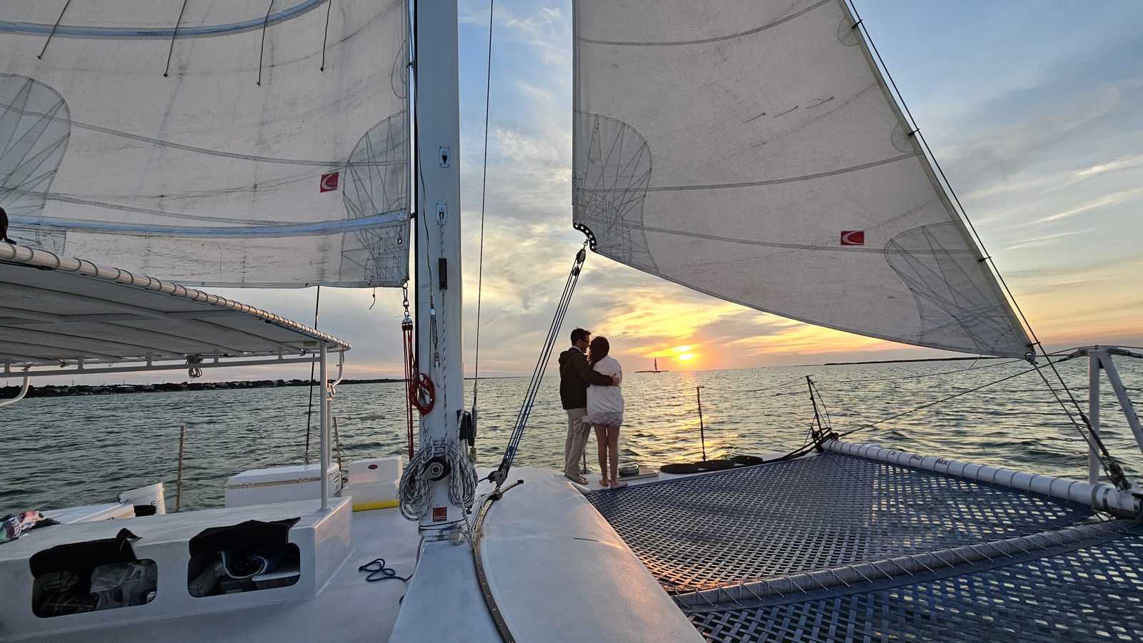 A guest photographing the sunset from the deck of the Carolina Moon