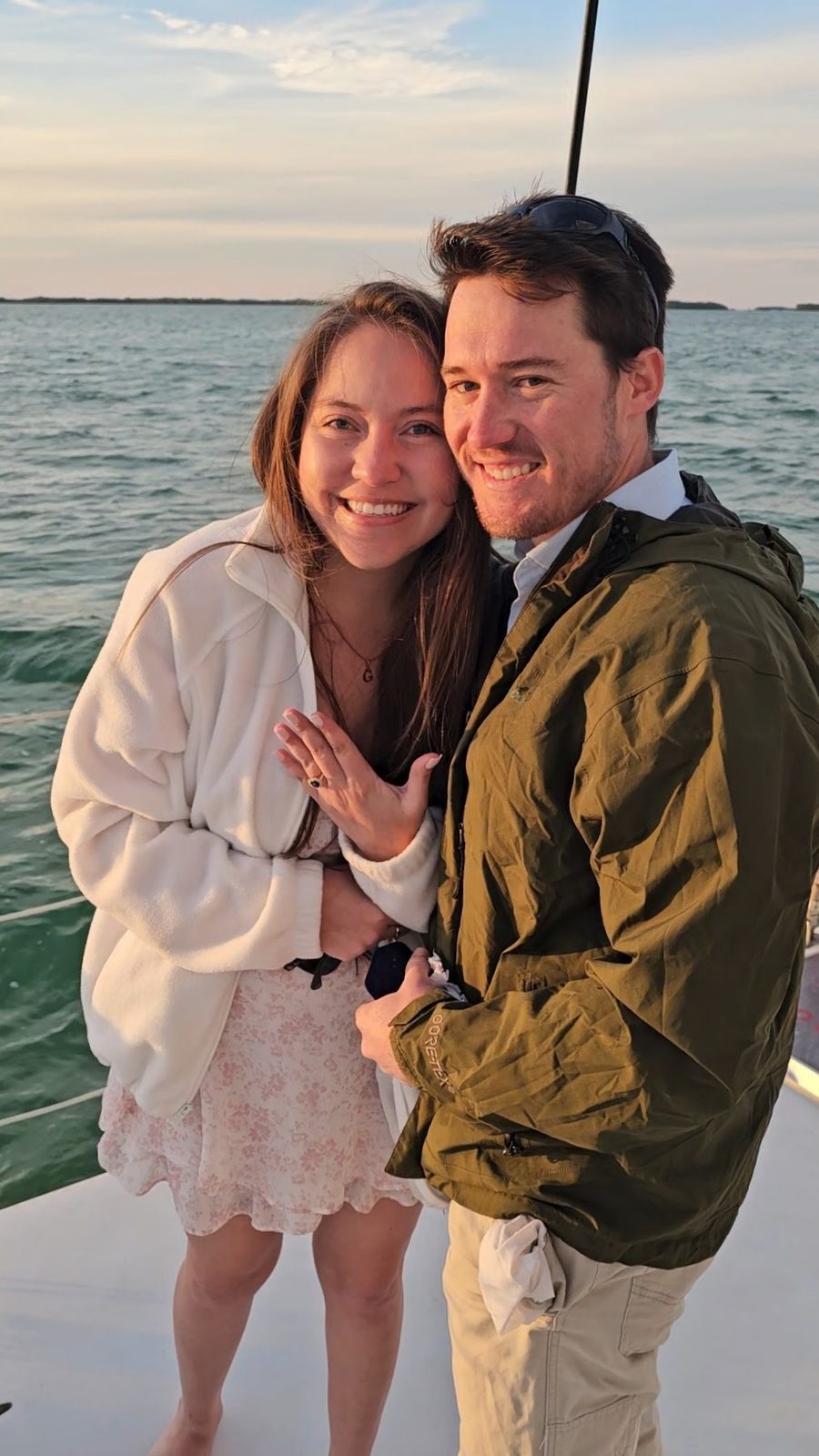 A couple sharing a Valentine's toast aboard the Carolina Moon at sunset