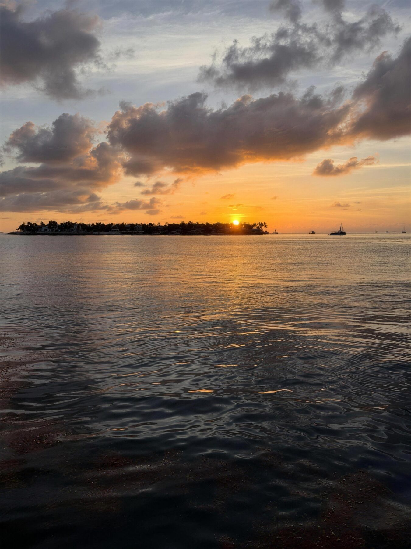 Golden Florida Keys sunset glowing over the calm water of Florida Bay
