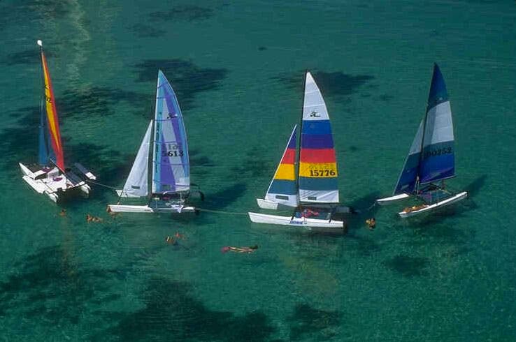 Aerial view of a fleet of Hobie catamarans sailing over the shallow flats of Florida Bay