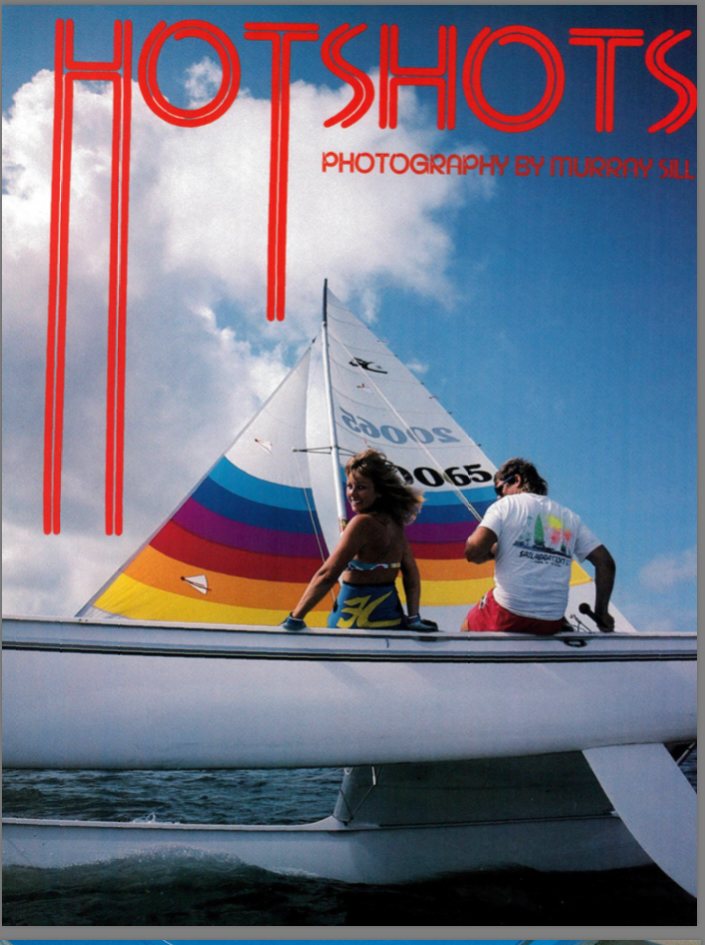 The cover of HOTSHOTS photography magazine featuring a rainbow-sailed Hobie catamaran